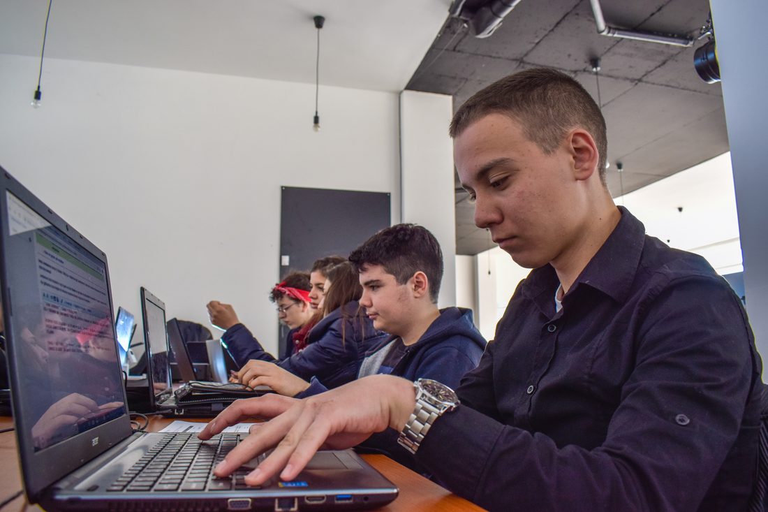 Volunteers gathered around laptops at an edit-a-thon focused on closing Wikipedia's gender gap