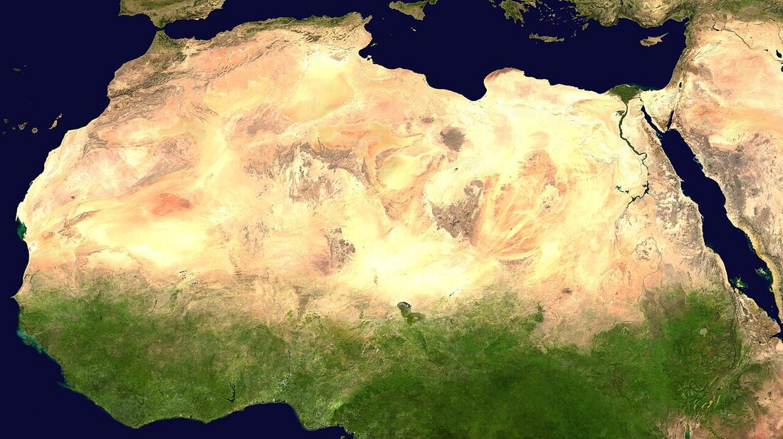 Satellite image of North Africa showing the Sahara desert as a vast tan expanse between the Mediterranean coast and the green Sahel