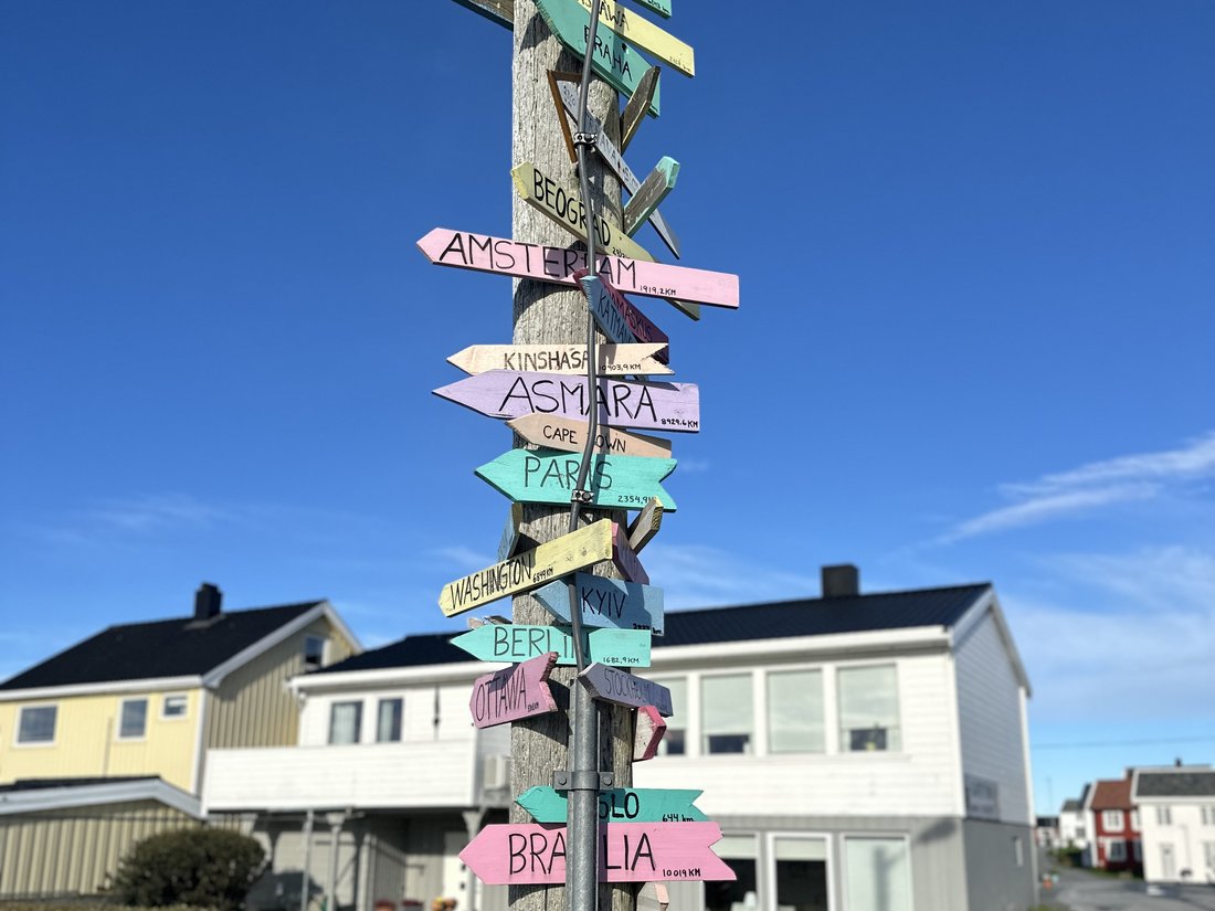 A signpost with many arrows pointing in different directions
